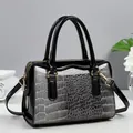 Chic Boston handbag with gradient crocodile pattern and black patent leather finish - Gray