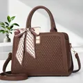 Detail of dark brown leather tote featuring lychee texture and silk scarf decoration - Coffee