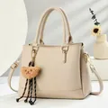 Retro cream Boston handbag with lychee texture, golden hardware and cute bear pendant - Khaki