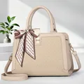 Detail of elegant beige crossbody bag with woven texture, metal lock and silk scarf accent - Off White