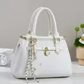 White tote bag with geometric texture, golden hardware, and stylish H-pendant decoration - White