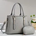 Grey tote bag set with matching coin purse featuring woven texture and gold hardware - Gray