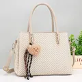 Beige woven tote bag with brown plush bear charm and adjustable shoulder strap - Khaki