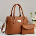 Detail of two-piece caramel brown leather tote bag set with lychee texture and gold hardware - 27x12x20cm / Earthy Yellow
