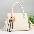 Detail of off-white woven handbag with cute bear charm and gold-tone hardware - Off White