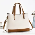 Elegant macaroon-colored handbag with lychee texture and stylish contrast shoulder strap - Off White