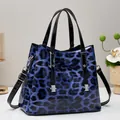 Blaue Tragetasche mit Leopardenmuster aus glänzendem Lackleder mit silbernen Metallteilen - Blau