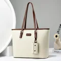 Chic cream tote bag with dark brown handles and a matching mini pouch charm - White