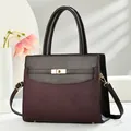 Women's two-tone top handle bag with woven texture, gold lock, and adjustable strap - Burgundy