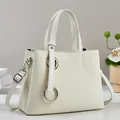 Detail of cream white tote bag featuring woven texture and silver metal rings - Off White