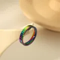 Polished 4mm rainbow stainless steel ring displayed on a white geometric stand - US 6 / Colorful