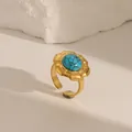 Vintage gold adjustable ring featuring a round turquoise stone in a floral setting - Adjustable Open / Turquoise Blue