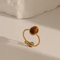 Vintage gold stainless steel open ring featuring an oval tiger eye stone and wavy edge - Adjustable Open / Tiger's Eye