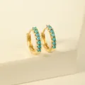 Detailed macro view of gold-plated hoop earrings featuring inlaid turquoise stones - Blue Hoop