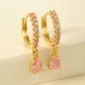 Detailed macro view of gold-plated earrings with drop pear-cut pink crystal accents - Pink Teardrop