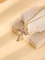 Detailed close-up of a gold-plated cross pendant necklace with colorful sparkling pavé crystals. - W1504 Cross Style 13