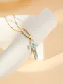 Gold plated stainless steel cross necklace detail shot with blue enamel and sparkling rhinestones. - W1496 Cross Style 21