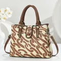 Close-up of printed canvas garden tote bag with premium leather handles and straps - Earthy Yellow