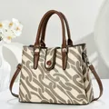 Elegant 2025 canvas tote bag with brown chain print and leather handles in white interior - Khaki