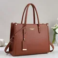 Detailed macro view of caramel brown lychee grain leather texture on high-quality tote bag - Earthy Yellow