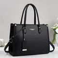 Elegant black leather tote bag with top handles and adjustable strap for business casual use - Black