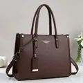 Elegant dark brown pebble leather tote bag with dual handles and adjustable shoulder strap - Coffee