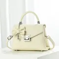 Elegant cream lychee pattern leather handbag with G-buckle and bow pearl charm - Off White