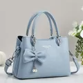 Light blue lychee pattern PU leather handbag with detachable strap and bow pendant - Blue