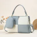 Detail of color-block leather handbag with V-logo, round handle and mini pouch charm - Light Blue