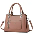 Detail of dusty pink pebbled leather handbag with silver hardware and fashion queen text - Pink