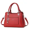 Fashionable red litchi grain tote bag with silver hardware and heart keychain - Red