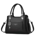 Fashionable black lychee leather handbag with silver Fashion Queen logo and chain charm - Black
