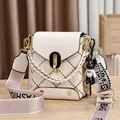 Quilted beige crossbody bag with gold rivets and trendy bear charm accessory - Quilted With Bear Pendant / Off White