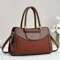 Elegant brown two-tone top-handle bag with gold hardware and fashion embossing - Brown
