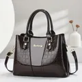 Elegant deep brown crocodile textured leather handbag with gold accents and shoulder strap - Coffee