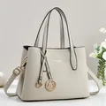 Elegant light gray faux leather handbag with gold hardware and adjustable strap - Off White