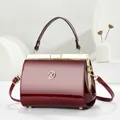 Elegant burgundy patent leather handbag with gold metallic frame and handle - Glossy Patent Style / Burgundy