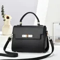 Elegant black pebbled leather crossbody handbag with gold hardware and top handle for women - Black