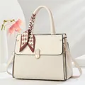 Elegant cream macaron handbag with embossed patchwork design and houndstooth scarf handle - Off White