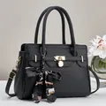 Elegant black litchi texture handbag with gold lock and floral scarf accessory - Black