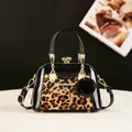 Detail of leopard print shell bag with gold crystal clasp and black rose pendant - Leopard Orange Red