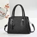 Black quilted top handle bag with star charm and adjustable strap for women - Black