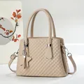 Close-up of beige quilted handbag with U-shaped metal buckle and star pendant detail - Apricot