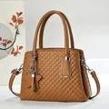 Close-up of brown quilted leather handbag with diamond stitching and star charm detail - Khaki/Earth Yellow