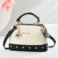 Cream and black quilted tote bag with gold stud accents and floral metallic charm - Off White