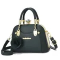Detail of dark green shell bag featuring gold metal frame and crystal clasp decoration - Dark Green