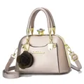 Detail of champagne gold leopard shell bag with diamond clasp and flower charm - Champagne
