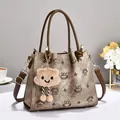 Detailed view of embroidery tote bag with leather handles and cute plush cloud charm - 24x10x20cm / Brown