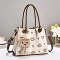Elegant monogram embroidered tote bag with cream base and brown handles for women - 24x10x20cm / Off-white