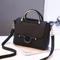 Black litchi pattern handbag with gold circular metal handles and detachable strap - Black